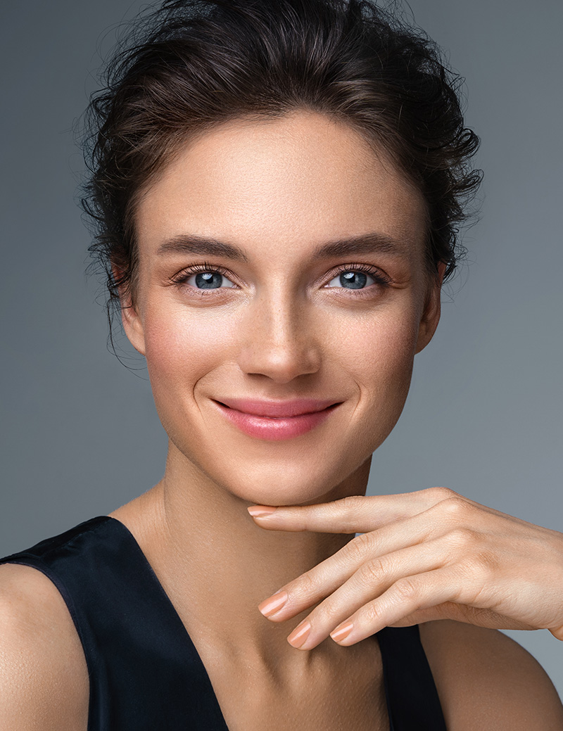 Beautiful woman with perfect makeup on gray background Beautiful woman with perfect makeup on gray background